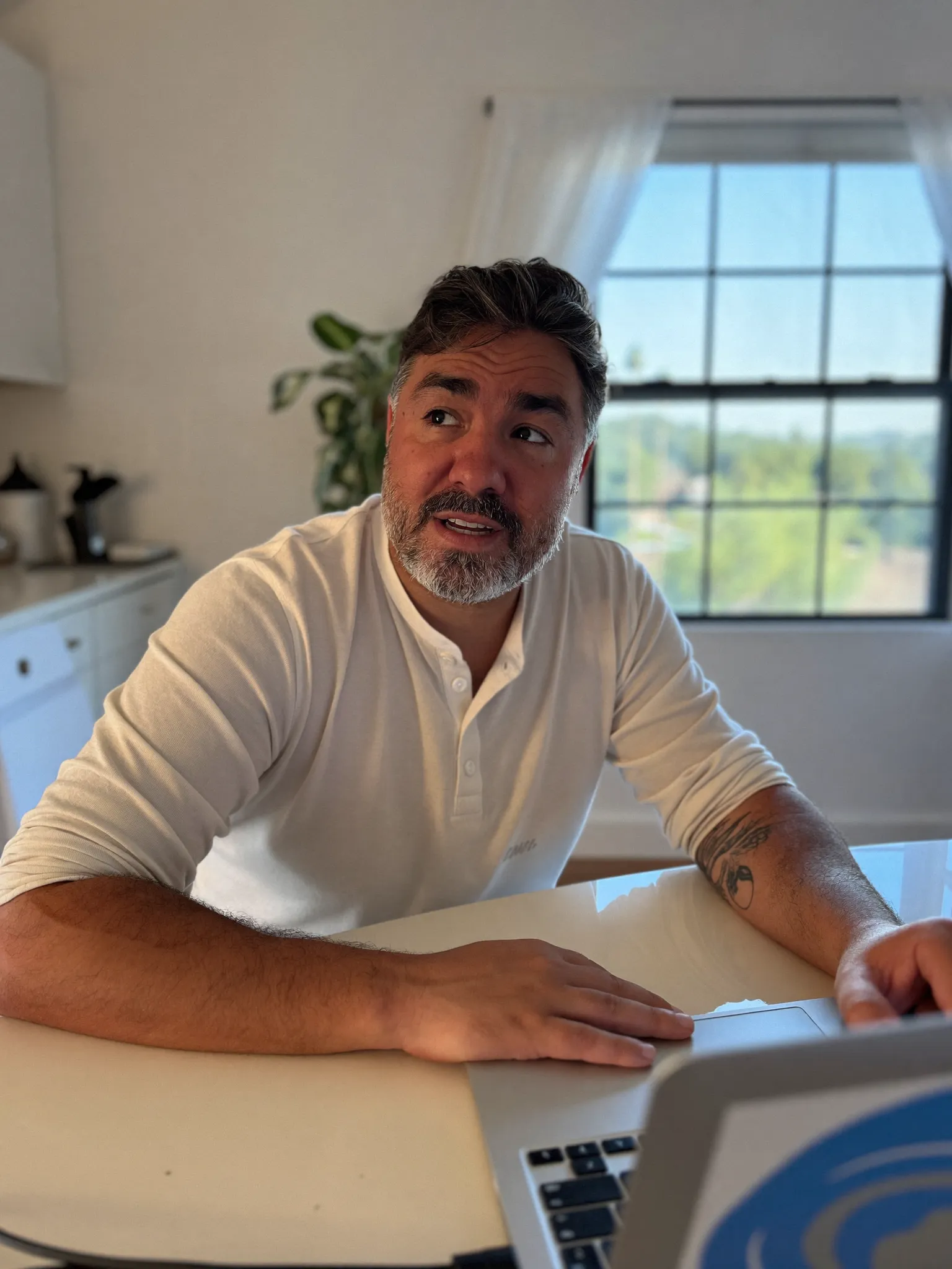 Marcus on a video telehealth consultation at his kitchen table