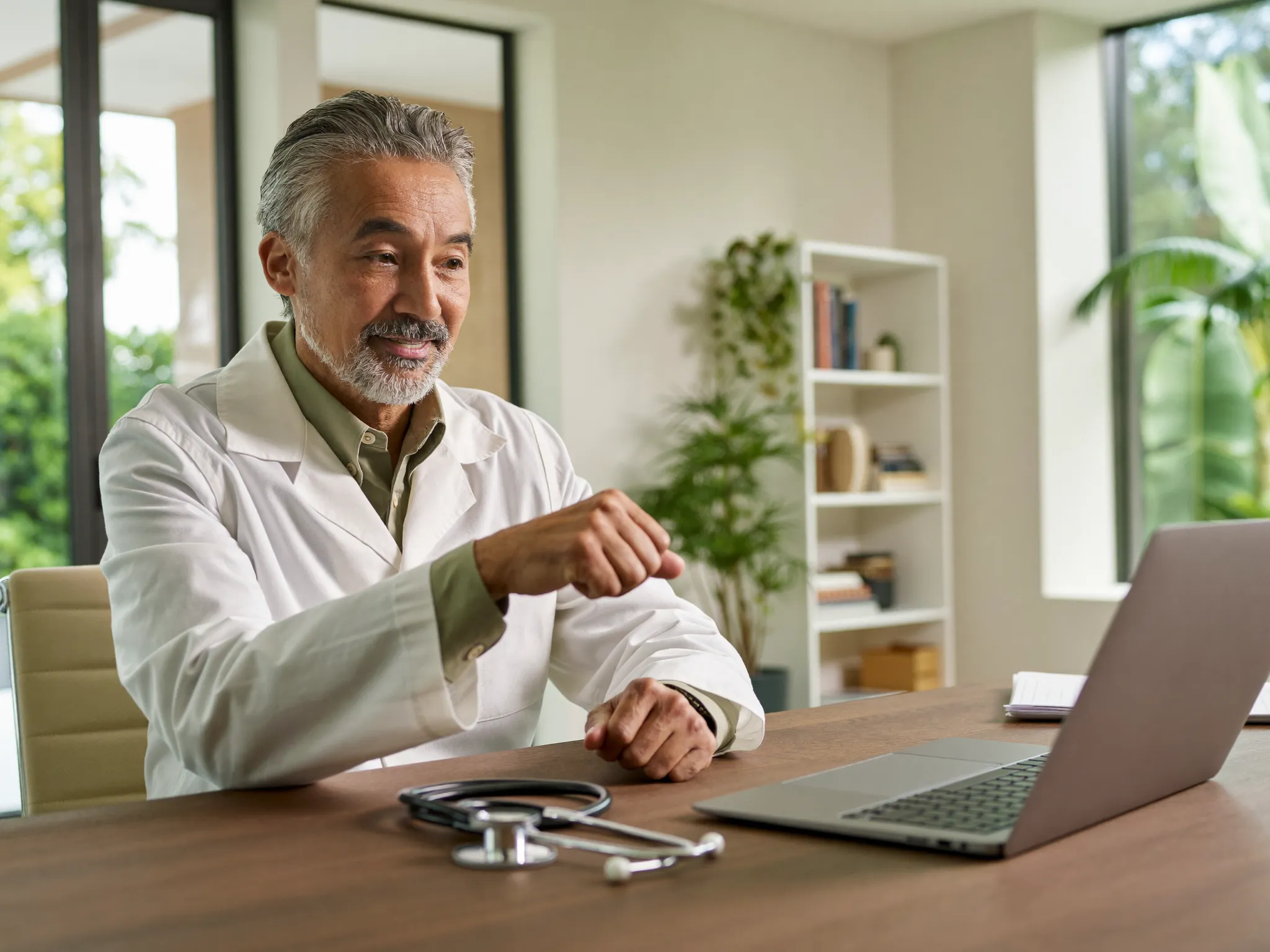 A physician in a white coat during a telehealth consultation